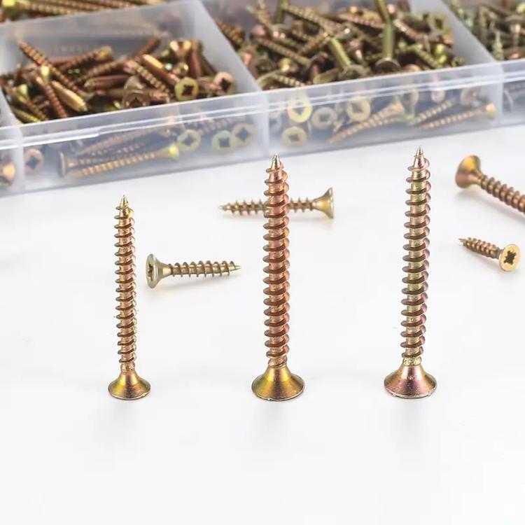 Yellow zinc plated flat head wood screws laid out, cross recessed drive heads visible