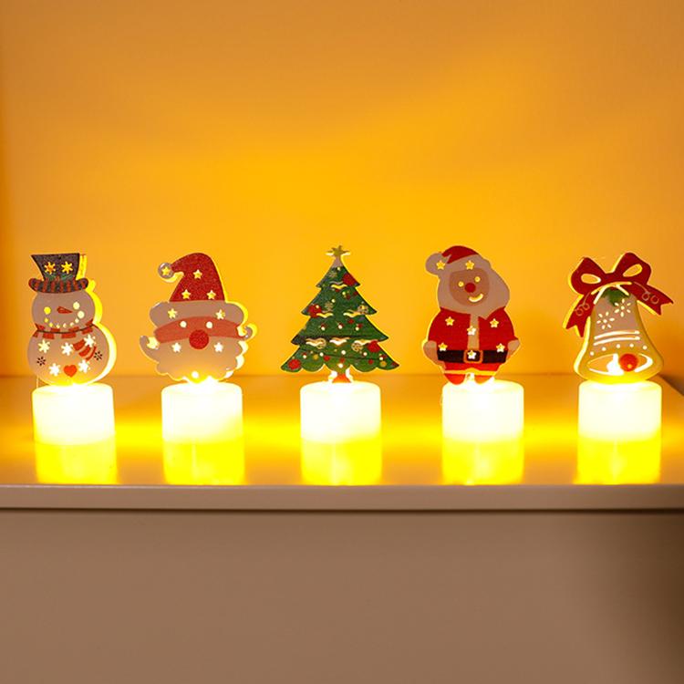Set of five LED character candle lights with warm glow on tabletop