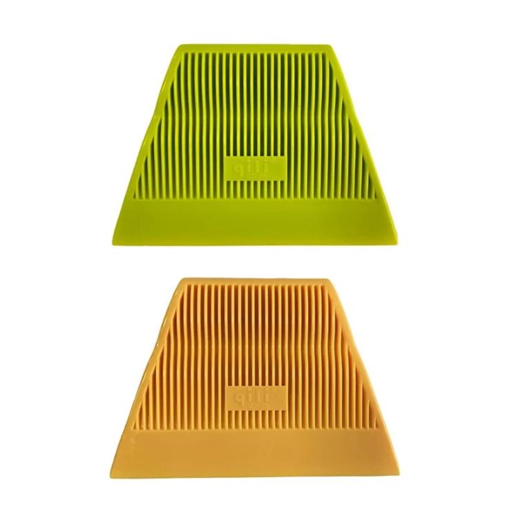 Green and yellow window tinting squeegees with ribbed groove scraper surfaces.