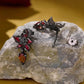 Gothic flower earrings with black finish, red petals, and amber teardrop charms