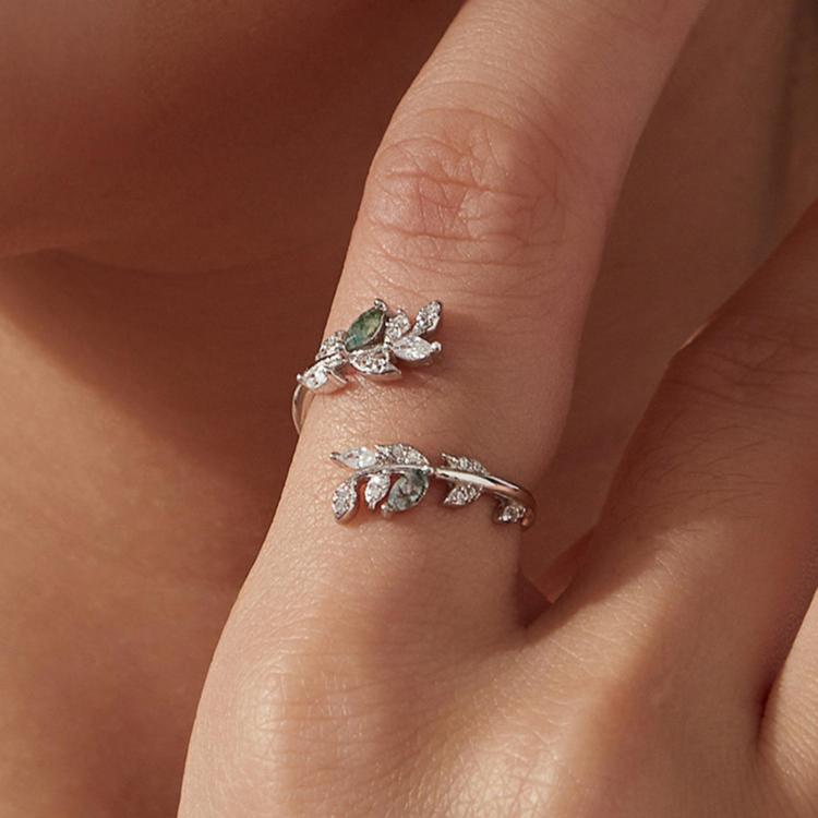 Sterling silver open leaf ring with green agate and crystal detailing on hand