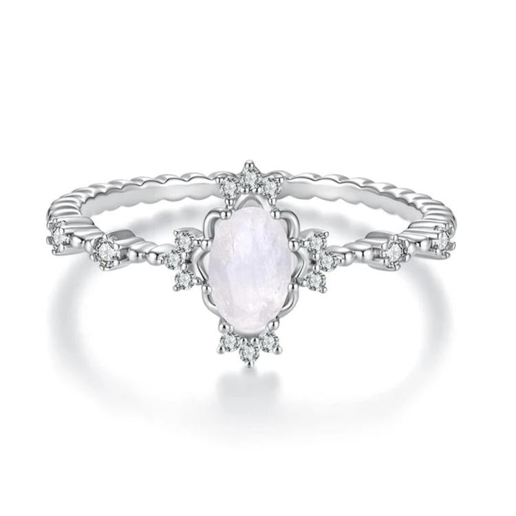 S925 sterling silver moonstone ring featuring an oval pale moonstone center and prong-set gems