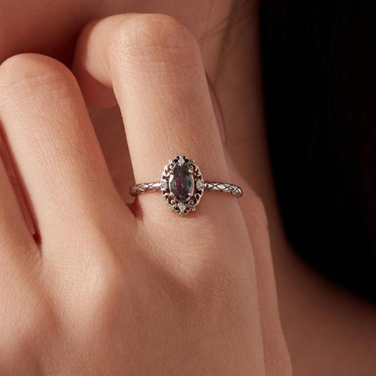 S925 silver open ring on finger with dark purple oval center stone and crystal accents