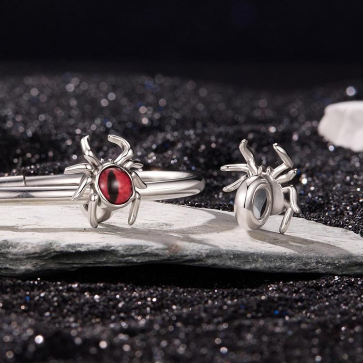 Sterling silver spider charm bead with red oval eye cabochon, angled side view