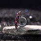 Sterling silver devil flower charm with magenta enamel petals and pink stones, side