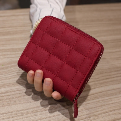 Wine red quilted mini coin purse with short zipper and gold-tone zipper pull