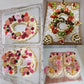 Frosted number cakes with flowers and berries arranged in two compartments