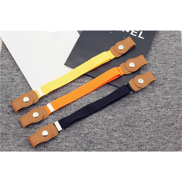 Kids elastic fabric belts with snap tabs in yellow, orange, and navy patterned straps.