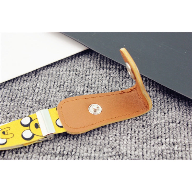 Children's elastic belt close-up: tan snap tab with silver rivet on yellow cartoon strap.
