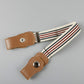 Kids elastic belt with tan snap tabs and cream/red striped woven fabric strap.