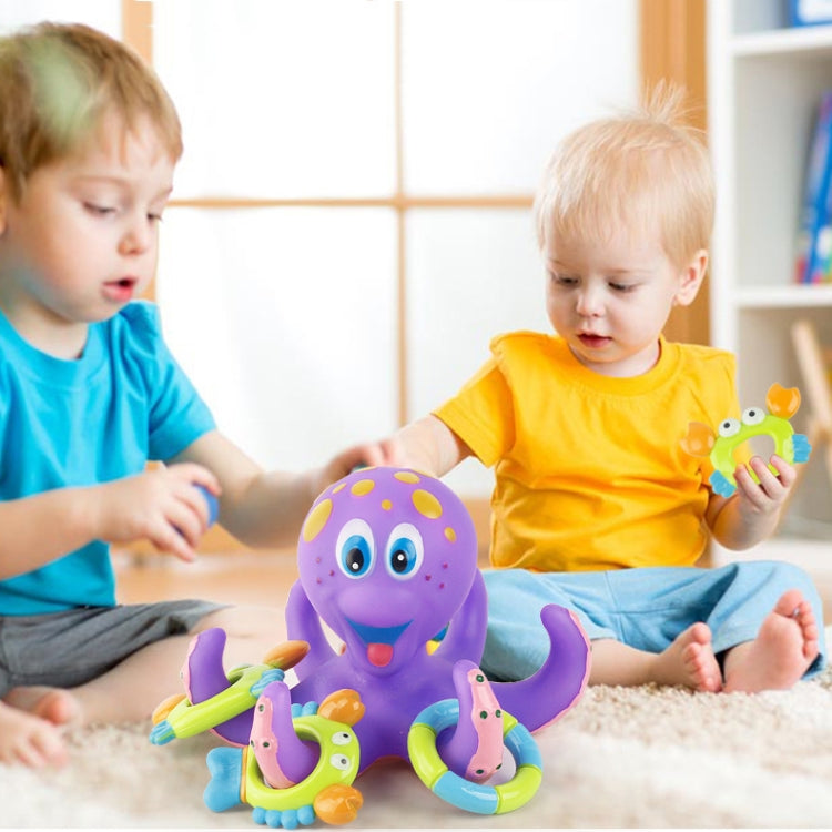 Purple octopus bath water toy on floor with kids and ring thrower accessories