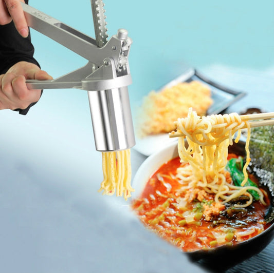 Hand-cranked stainless steel pasta machine producing spaghetti noodles