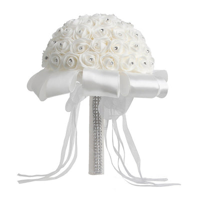 White rose-bud wedding bouquet with satin ribbons and rhinestone-wrapped handle