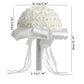 White rose-bud wedding bouquet with rhinestone handle, satin bow, and ribbon streamers