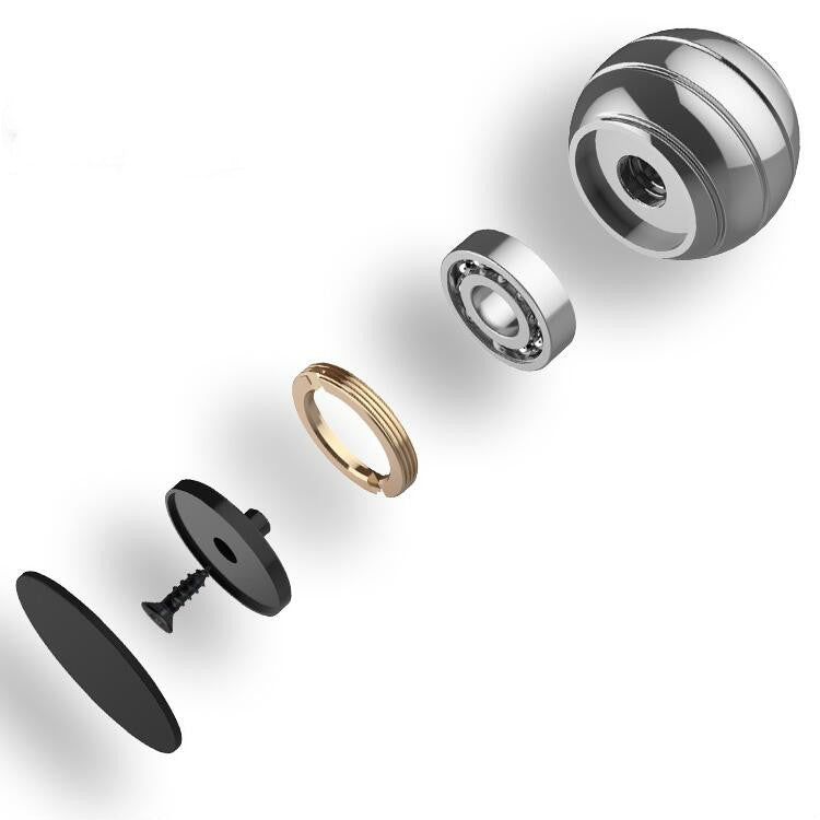 Exploded view of rotating ball gyroscope toy parts: silver dome, gold ring, black base.