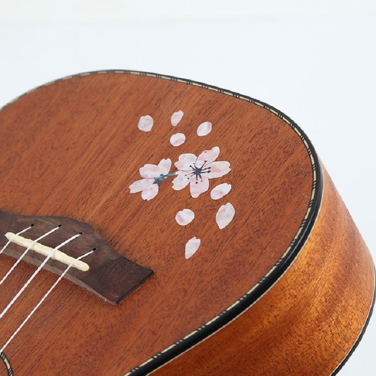Cherry blossom stickers on wood acoustic guitar top, white petals and flower