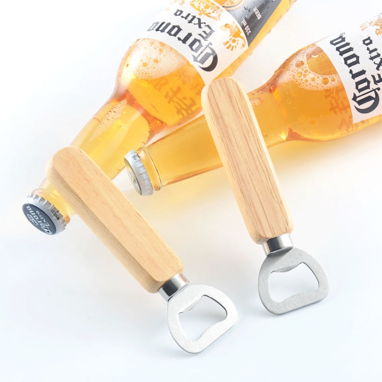 Pair of beer bottle openers with rubber wood handles lifting caps from bottles