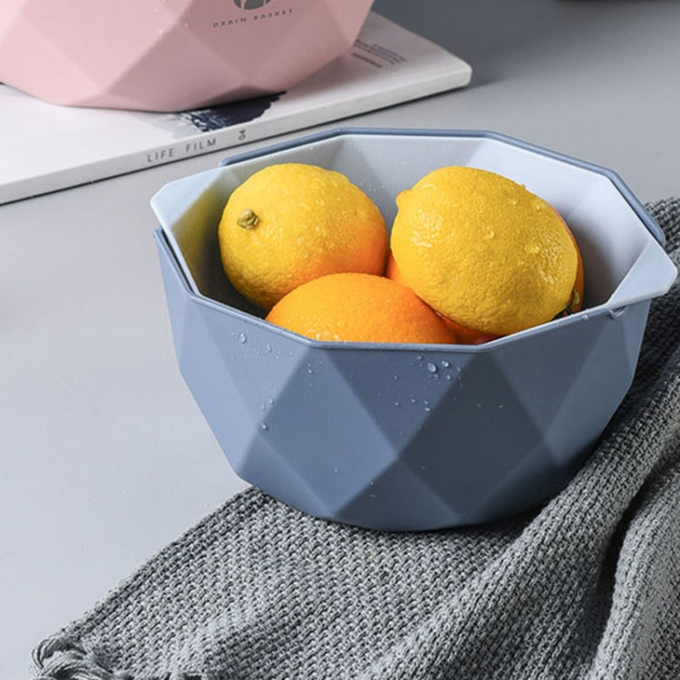 Blue double-layer drain basket with citrus fruit and perforated drain base