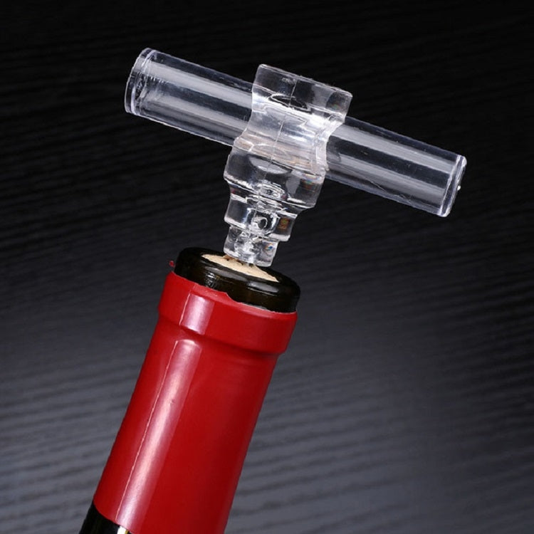 Wine corkscrew with clear top and red plastic base, spiral worm