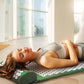 Green acupuncture massage mat with white acupoints and pillow used for body support