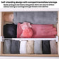 White plastic drawer divider with multiple compartments, holding neatly stacked fabrics.
