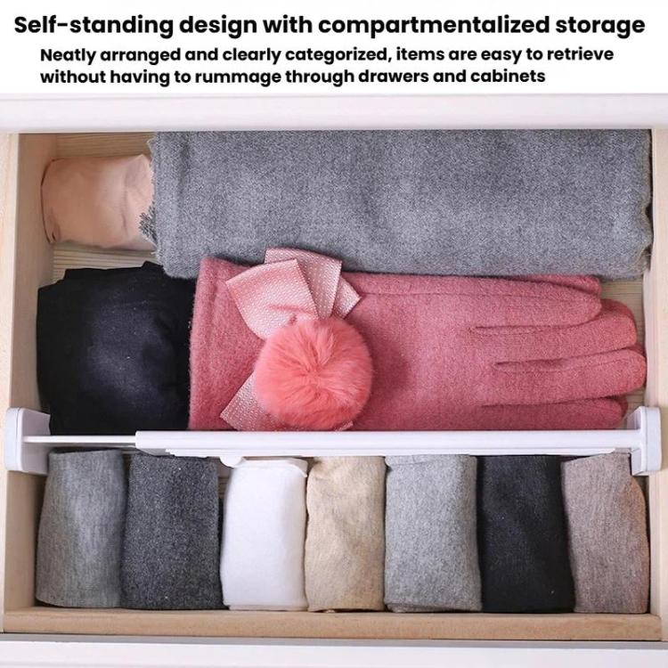 White plastic drawer divider with multiple compartments, holding neatly stacked fabrics.