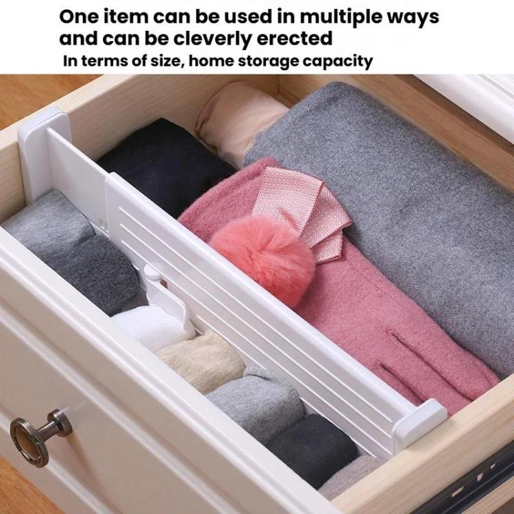 White extendable divider separating clothing compartments in an open drawer.