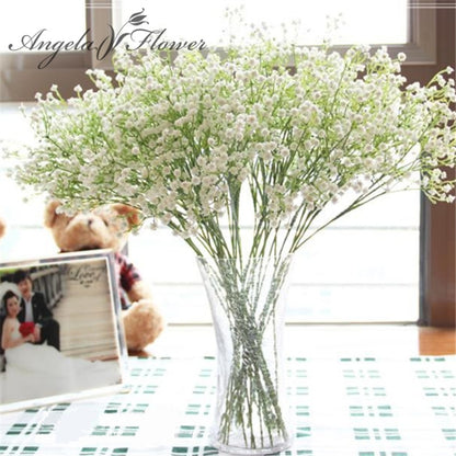 Artificial baby's breath flower bouquet in clear vase, white blooms on green stems