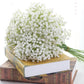Artificial baby's breath bouquet with dense white mini flowers on books