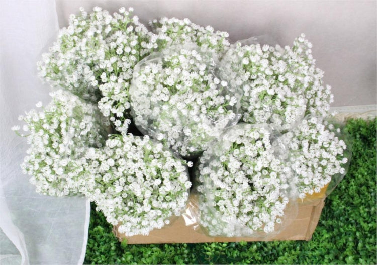 Artificial baby's breath flowers in a brown planter basket with white blossoms