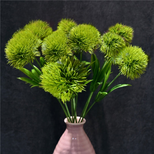 Green artificial dandelion flower stems bouquet in a vase