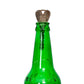 Metal magic key inserted into top of green glass bottle prop