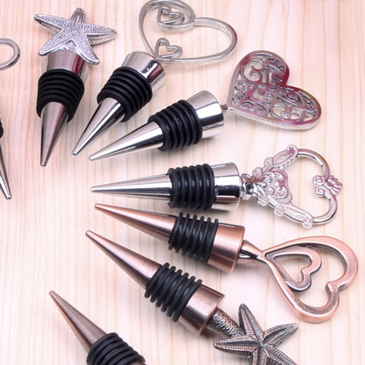 Set of metal wine stoppers with starfish, heart, and ring charms