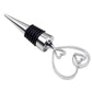 Metal wine stopper with heart-shaped loop handle, black ribbed collar, silver finish.
