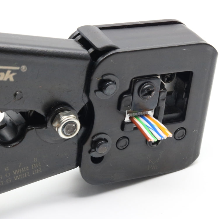 Close-up of black tool body with wire entry ports and colored cable ends