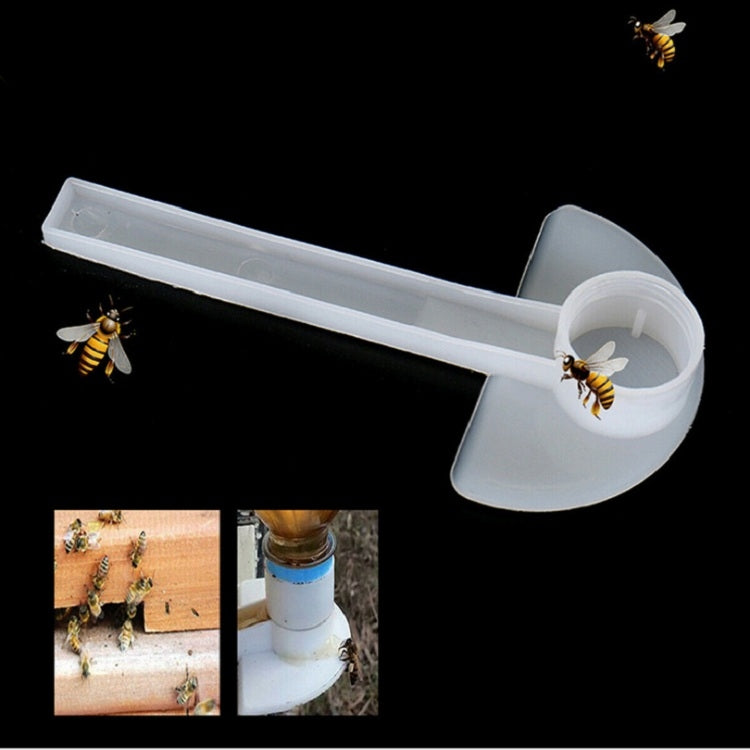 White bee water feeder door cap on a long tube, angled for access