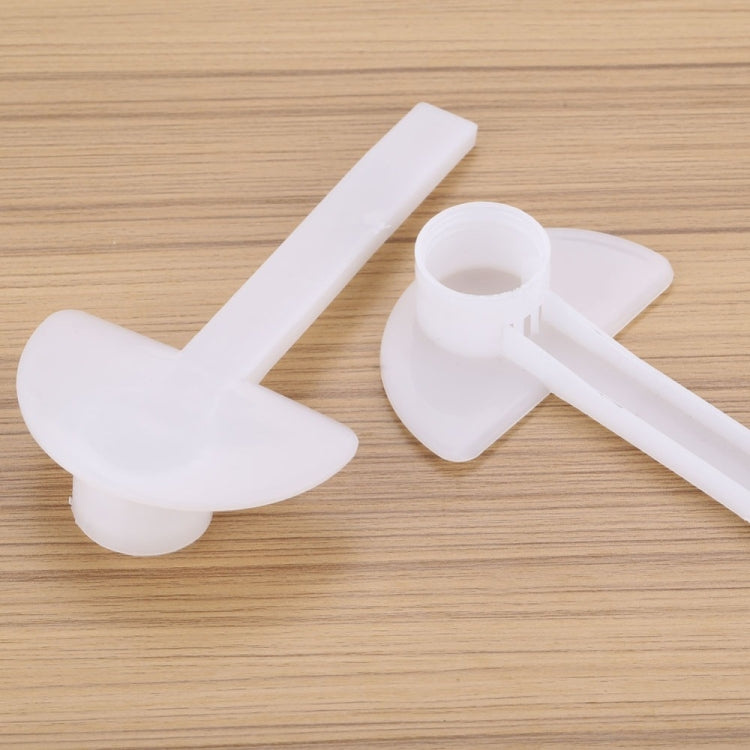 White duckbill feeder cap with bottle holder and long spout on wooden surface