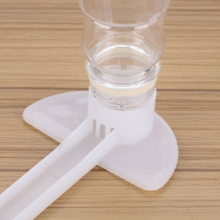 Close-up of clear water bottle reservoir connected to white bee feeder cap and stem