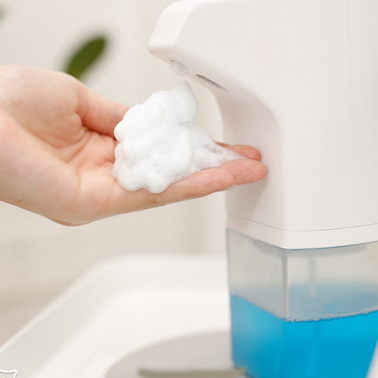Wall-mounted automatic foam soap dispenser dispensing foamy soap onto hand