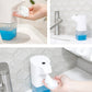 Wall-mounted automatic foam soap dispenser with blue reservoir, foamy soap in hand