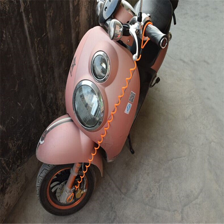Alarm disc lock cable wrapped on a parked scooter, showing orange coiled spring