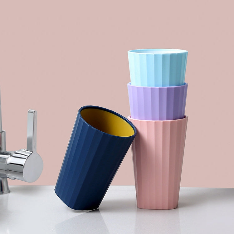 Toothbrush rinse cups set: blue and pink ribbed cups with curved handles.