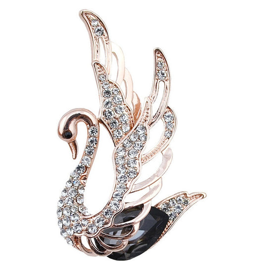 Rose-gold tone swan crystal brooch with clear stone detailing and curved wings