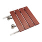 Folding wall-mounted shower chair with wood slats, chrome arms, and locking hardware