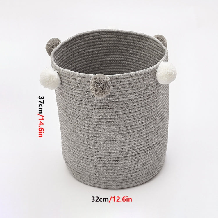 Gray fabric laundry or toy storage basket with pom-pom side handles