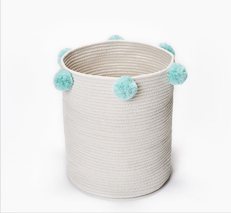 Cream fabric storage basket with light blue pom-pom handles and round rim