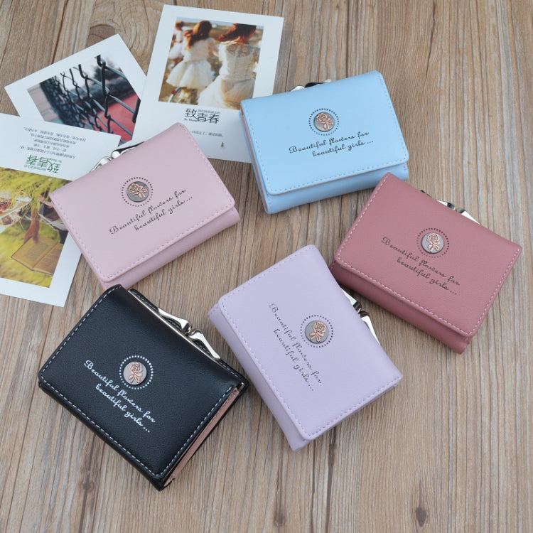 Small folding coin purse wallets in multiple colors, each with floral emblem and clasp