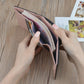 Folding coin purse wallet held open, showing interior lining and card compartments