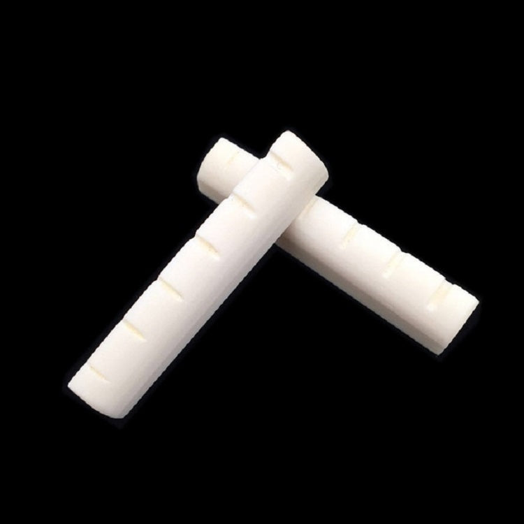 Ox bone guitar string bridge pillow pair in an angled T shape