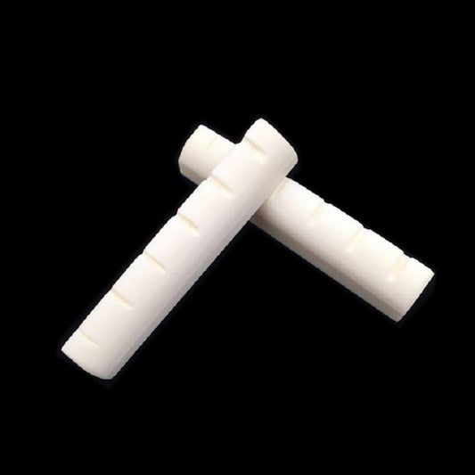 Ox bone guitar string bridge pillow pair in an angled T shape